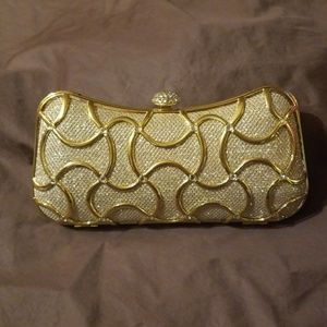 Fawziya Crystal clutch with gold chained strap.